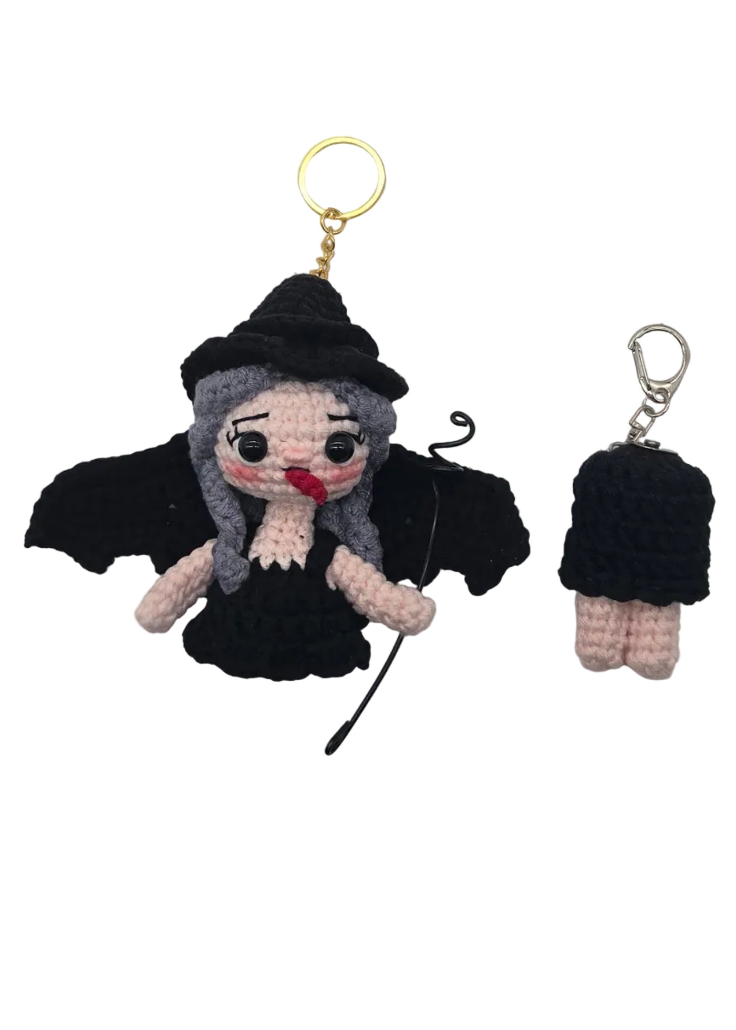 Two small crocheted keychains on a plain white background, one upper body half with a gold key ring and one lower body half with a silver key ring.