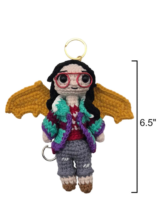 Crocheted keychain with yellow wings, red glasses, and a colorful sweater, shown with a 6.5-inch height measurement marker on a white background.