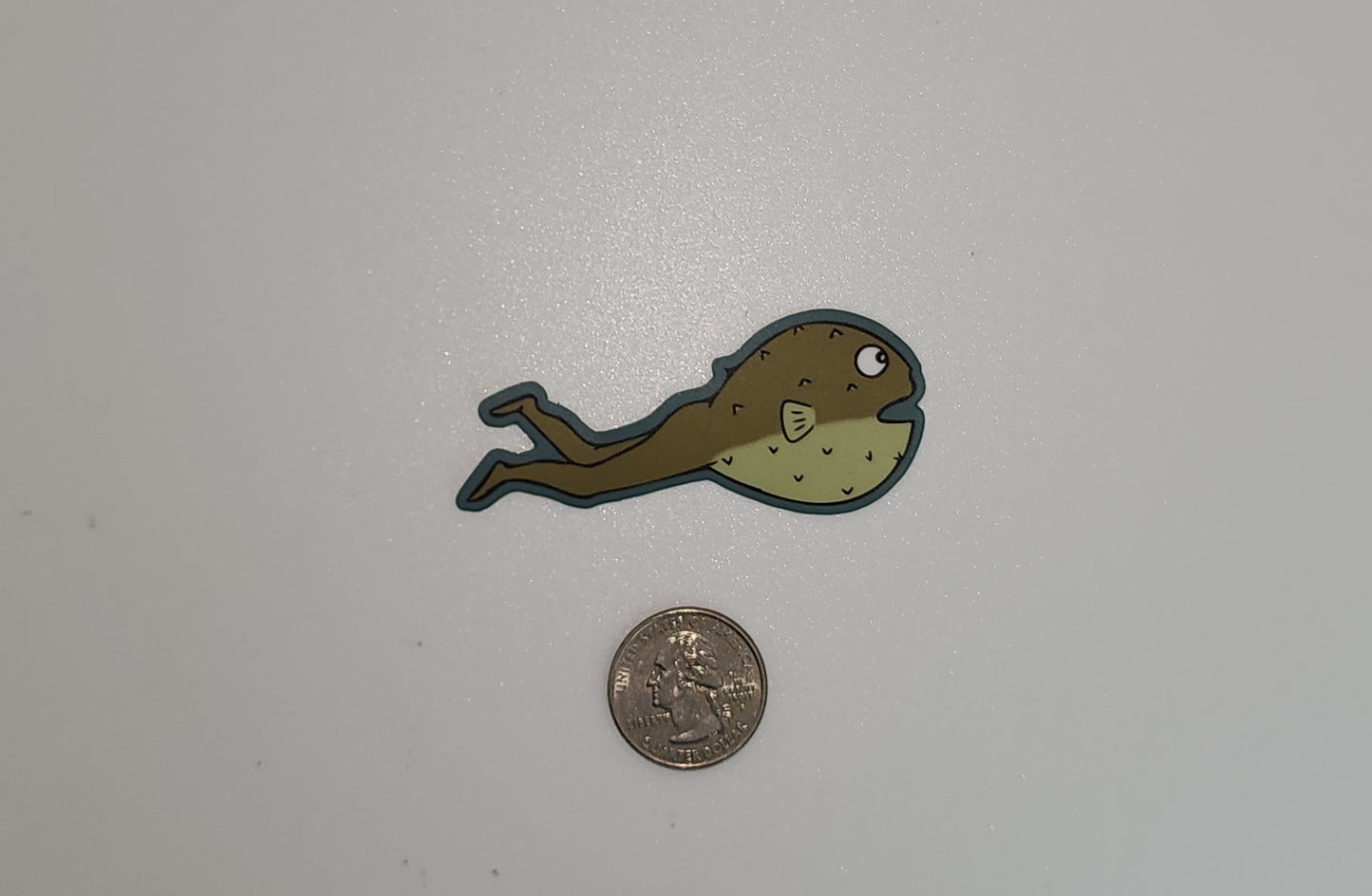 catao sticker with quarter for scale