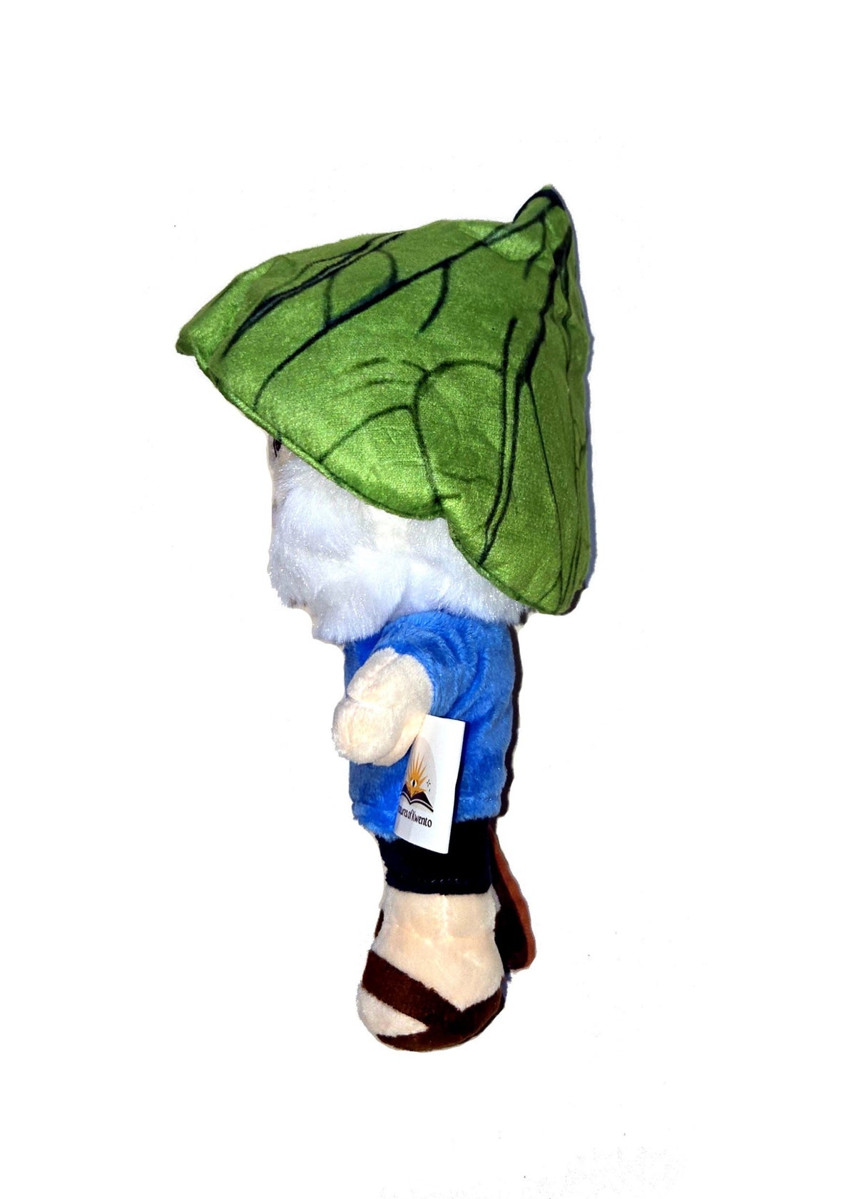 Left side view of the dwende plush. It shows the green hat that looks like a leaf is cone-shaped. There is nothing in his left hand.