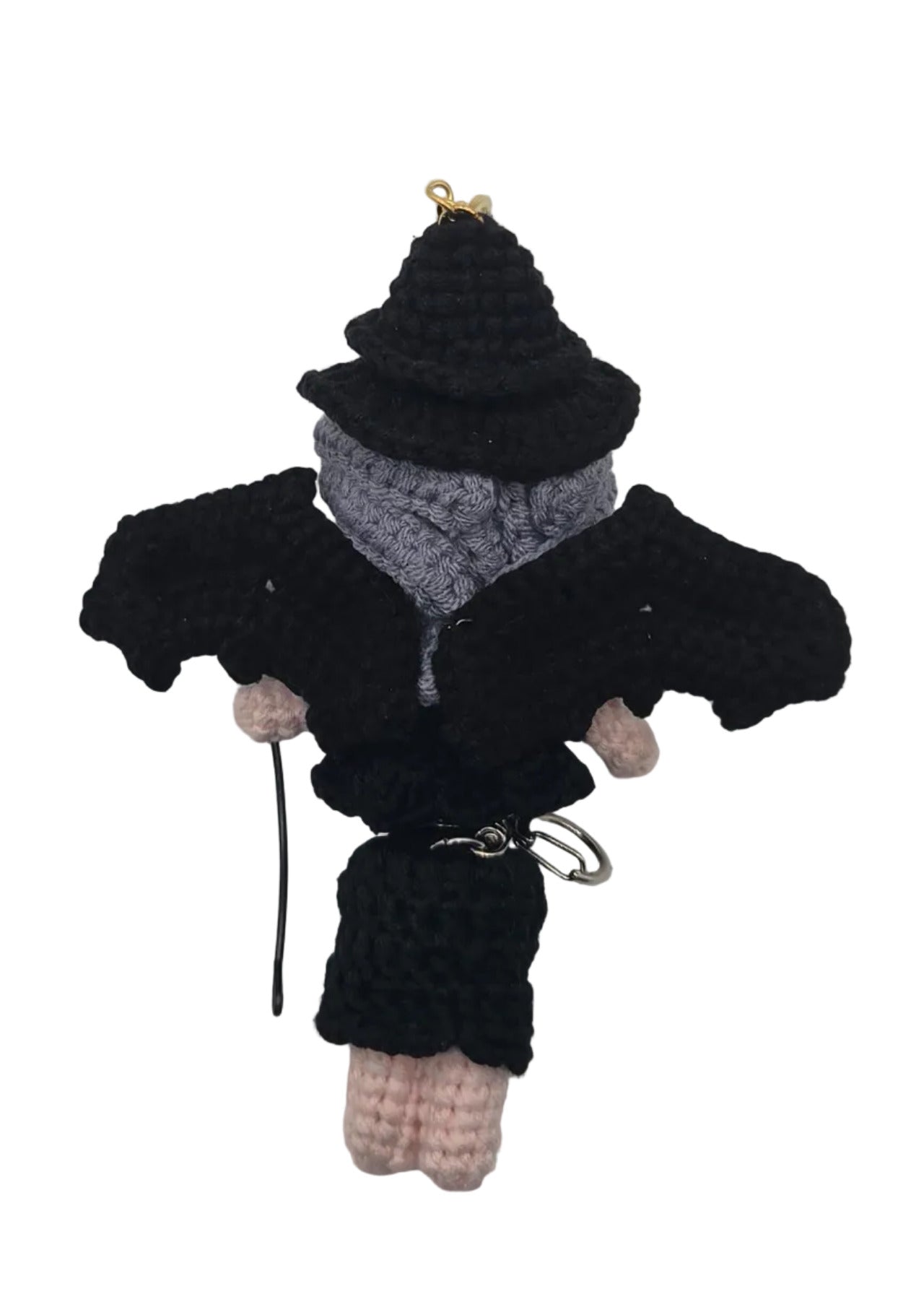A small manananggal doll dressed in a black outfit, on a plain white background.
