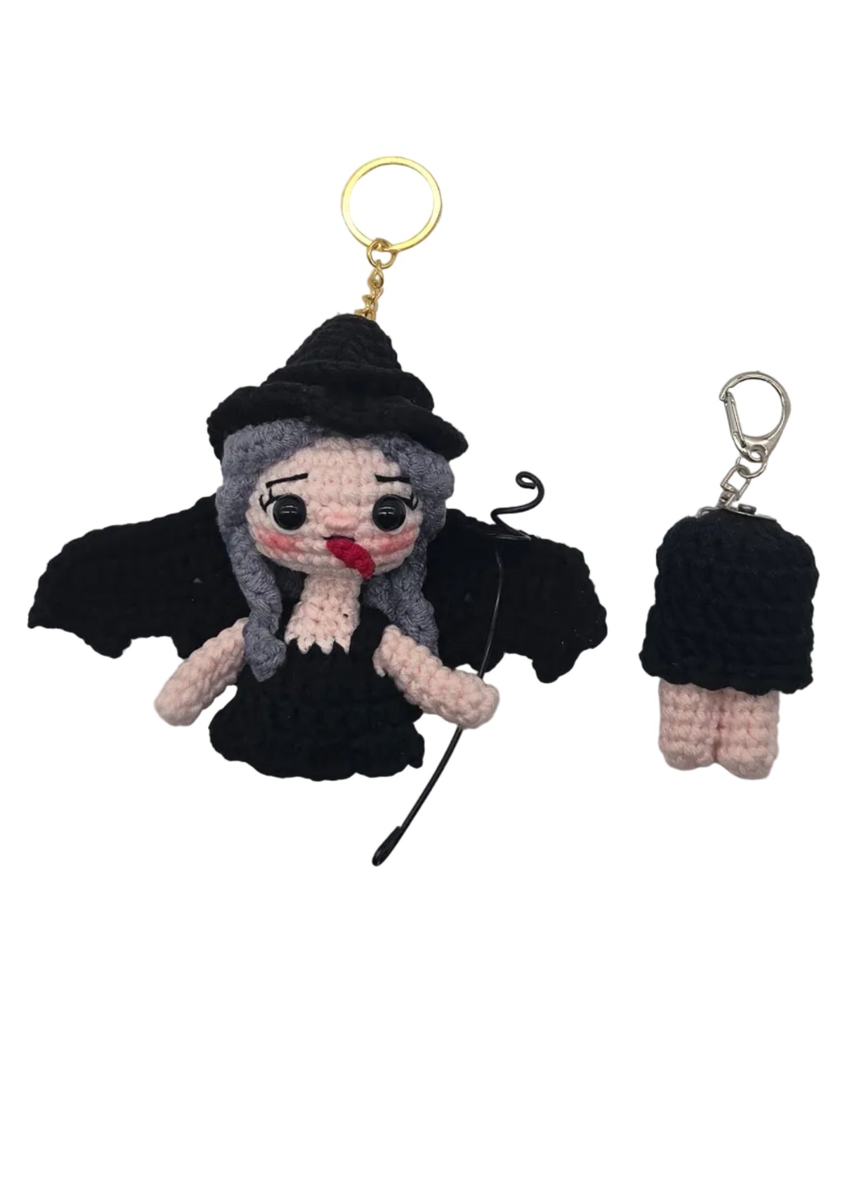 Two small crocheted keychains on a plain white background, one upper body half with a gold key ring and one lower body half with a silver key ring.